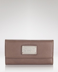 Fall for the enduring style of this MARC BY MARC JACOBS leather wallet. It's compact enough to slip inside your it-bag, yet large enough to handle the essentials. Fall for the enduring style of this MARC BY MARC JACOBS leather wallet. It's compact enough to slip inside your it-bag, yet large enough to handle the essentials.