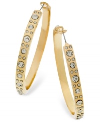 Add a spark to your look with these shimmering hoops from GUESS. A golden silhouette is embellished with glass accents. Crafted in gold tone mixed metal. Approximate diameter: 2-1/4 inches. Add a spark to your look with these shimmering hoops from GUESS. A golden silhouette is embellished with glass accents. Crafted in gold tone mixed metal. Approximate diameter: 2-1/4 inches.