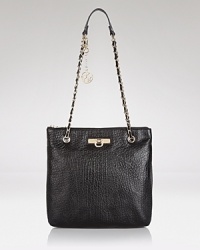 High shine hardware gives this simple and sleek convertible bag from DKNY a hit of cool. Style it over the shoulder or carry it across the body to tap this bag's versatile appeal. High shine hardware gives this simple and sleek convertible bag from DKNY a hit of cool. Style it over the shoulder or carry it across the body to tap this bag's versatile appeal.