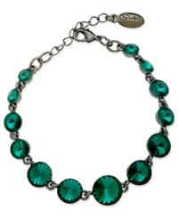 Circular chic. This bracelet from GUESS is crafted from hematite-tone mixed metal with teal glass crystal stones adding a vibrant touch. Item comes packaged in a signature GUESS Gift Box. Approximate length: 7-1/2 inches. Circular chic. This bracelet from GUESS is crafted from hematite-tone mixed metal with teal glass crystal stones adding a vibrant touch. Item comes packaged in a signature GUESS Gift Box. Approximate length: 7-1/2 inches.