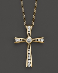 Diamonds set in a 14K yellow gold cross. Diamonds set in a 14K yellow gold cross.