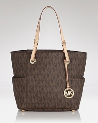 Put a signature spin on your look with this embossed PVC tote from MICHAEL Michael Kors. Stamped with the label's iconic monogram, this perennially chic piece is a must for any logo-loving fashionista. Put a signature spin on your look with this embossed PVC tote from MICHAEL Michael Kors. Stamped with the label's iconic monogram, this perennially chic piece is a must for any logo-loving fashionista.