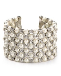 Crystals and pearls compose an elegant statement on this Carolee cuff, styled to add a touch of drama to your out-at-night finery. Crystals and pearls compose an elegant statement on this Carolee cuff, styled to add a touch of drama to your out-at-night finery.