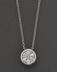 A stunning diamond cluster is bezel-set in 14K white gold. A stunning diamond cluster is bezel-set in 14K white gold.