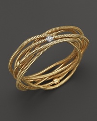 A multi-strand, shining 18K yellow gold bangle, accented with diamonds. A multi-strand, shining 18K yellow gold bangle, accented with diamonds.