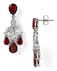 A rich cascade of ruby-red colored stones illuminates this pair of Nadri chandelier earrings, which flaunts an elegant allure, set off by rhodium plated metal. A rich cascade of ruby-red colored stones illuminates this pair of Nadri chandelier earrings, which flaunts an elegant allure, set off by rhodium plated metal.