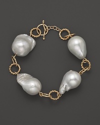 Boldly gleaming baroque freshwater pearls add rich luster to 14K yellow gold. By Nancy B. Boldly gleaming baroque freshwater pearls add rich luster to 14K yellow gold. By Nancy B.