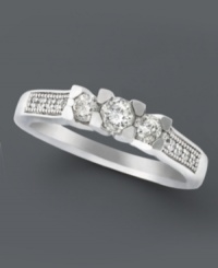 A stunning engagement ring with a modern twist. A three stone diamond design (1/2 ct. t.w.) complemented by round-cut diamond side stones shines in a 14k white gold setting. A stunning engagement ring with a modern twist. A three stone diamond design (1/2 ct. t.w.) complemented by round-cut diamond side stones shines in a 14k white gold setting.