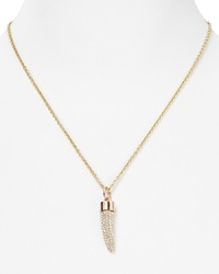 A bold crystal bedecked horn adorns a simply styled link chain on a powerful Rebecca Minkoff pendant necklace, crafted of plated brass. A bold crystal bedecked horn adorns a simply styled link chain on a powerful Rebecca Minkoff pendant necklace, crafted of plated brass.