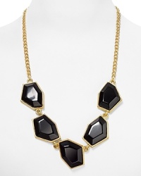 A lesson in geometry: this Kenneth Jay Lane necklace works the angles with a frontal of resin hexagons, which make a classic link chain feel modern. A lesson in geometry: this Kenneth Jay Lane necklace works the angles with a frontal of resin hexagons, which make a classic link chain feel modern.