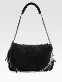 An edgy style in soft shearling accented with leather trim and shiny chain link accents.Adjustable leather and shearling shoulder strap, 12-21½ dropFlap closureOne zip pocket on flapOne inside zip pocket17W X 9H X 4DMade in Italy An edgy style in soft shearling accented with leather trim and shiny chain link accents.Adjustable leather and shearling shoulder strap, 12-21½ dropFlap closureOne zip pocket on flapOne inside zip pocket17W X 9H X 4DMade in Italy