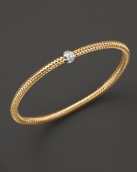 A single diamond station shines on this modern 18K gold mesh bangle from Roberto Coin. A single diamond station shines on this modern 18K gold mesh bangle from Roberto Coin.