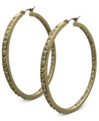 Fashion that covers all bases. These golden hoop earrings from GUESS sparkle both inside and out with glass accents. Crafted in gold tone mixed metal. Approximate drop: 2 inches. Fashion that covers all bases. These golden hoop earrings from GUESS sparkle both inside and out with glass accents. Crafted in gold tone mixed metal. Approximate drop: 2 inches.