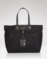 A favorite of stylish moms, this nylon MARC BY MARC JACOBS baby bag features an effortless on-duty design, with pockets to keep the essentials organized and at the ready. A favorite of stylish moms, this nylon MARC BY MARC JACOBS baby bag features an effortless on-duty design, with pockets to keep the essentials organized and at the ready.