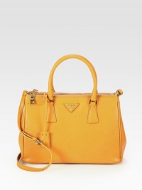 Luxurious saffiano lux leather in a classic shape with a convenient removable shoulder strap.Double top handles, 5 dropDetachable adjustable shoulder strap, 16½-18¾ dropThree inner compartments; two top zip and one open topProtective metal feetOne inside zip pocketOne inside open pocketSignature jacquard lining11¾W X 8H X 5DMade in Italy Luxurious saffiano lux leather in a classic shape with a convenient removable shoulder strap.Double top handles, 5 dropDetachable adjustable shoulder strap, 16½-18¾ dropThree inner compartments; two top zip and one open topProtective metal feetOne inside zip pocketOne inside open pocketSignature jacquard lining11¾W X 8H X 5DMade in Italy