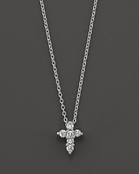 From the Tiny Treasures collection, a diamond Cross necklace makes a religious statement; with signature ruby accent. Designed by Roberto Coin. From the Tiny Treasures collection, a diamond Cross necklace makes a religious statement; with signature ruby accent. Designed by Roberto Coin.