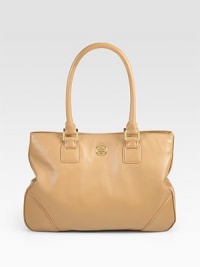A clean design of luxe pebble-grain leather, with a signature goldtone emblem and side snaps for a cinched shape. Double top handles, 7½ dropMagnetic snap closureSide snapsProtective metal feetOne inner zip compartmentOne inside zip pocketTwo inside open pocketsCanvas lining13W X 9½H X 4DImported A clean design of luxe pebble-grain leather, with a signature goldtone emblem and side snaps for a cinched shape. Double top handles, 7½ dropMagnetic snap closureSide snapsProtective metal feetOne inner zip compartmentOne inside zip pocketTwo inside open pocketsCanvas lining13W X 9½H X 4DImported
