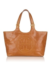 Express your Tory Burch style with this luxe bombe glazed leather tote. The bestselling style is crafted in a chic oversized silhouette and embossed with her signature logo. Express your Tory Burch style with this luxe bombe glazed leather tote. The bestselling style is crafted in a chic oversized silhouette and embossed with her signature logo.