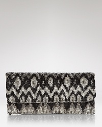 A bohemian Ikat motif is effortlessly glamorous on this beaded MOYNA clutch, styled in a slim fold-over silhouette. A bohemian Ikat motif is effortlessly glamorous on this beaded MOYNA clutch, styled in a slim fold-over silhouette.