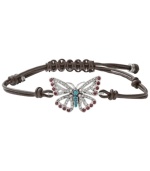 Fashionably fluttering. Fossil's free-spirited butterfly bracelet features purple and clear-colored crystals, reconstituted turquoise, and a chocolate leather adjustable wrist wrap. Set in silver tone mixed metal. Approximate diameter: 2-1/2 inches.