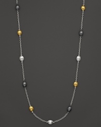 Tricolor, almond-shaped stations in gold and sterling silver shine on this modern necklace from Gurhan. Tricolor, almond-shaped stations in gold and sterling silver shine on this modern necklace from Gurhan.