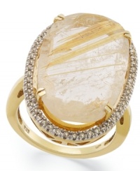 The golden rule. This stunning statement ring features an oval-cut golden rutilated quartz (12-3/8 ct. t.w.) that stands out against a sparkling diamond frame (1/4 ct. t.w.). Set in 14k gold over sterling silver. Size 7.
