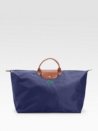 This ultra versatile tote is sized and shaped for the shopping, travel, the gym or just about anything, and crafted of silky nylon with rich leather trim.Double handles, 3½ drop Top zipper close with snap flap Inside open pocket Fully lined Nylon canvas; leather trim 28W X 15½H X 9D ImportedFOR PERSONALIZATIONSelect a color and quantity, then scroll down and click on PERSONALIZE & ADD TO BAG to choose and preview your monogramming options. This ultra versatile tote is sized and shaped for the shopping, travel, the gym or just about anything, and crafted of silky nylon with rich leather trim.Double handles, 3½ drop Top zipper close with snap flap Inside open pocket Fully lined Nylon canvas; leather trim 28W X 15½H X 9D ImportedFOR PERSONALIZATIONSelect a color and quantity, then scroll down and click on PERSONALIZE & ADD TO BAG to choose and preview your monogramming options.