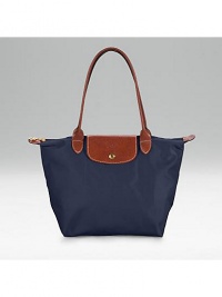 Pliage nylon signature tote, great for travel as well as everyday use. Top zip plus leather top handle, shoulder drop, 7½ Snap flap Inside pocket Folds up and snaps closed Opens to 9¾W X 9¾H x 5½D Imported Pliage nylon signature tote, great for travel as well as everyday use. Top zip plus leather top handle, shoulder drop, 7½ Snap flap Inside pocket Folds up and snaps closed Opens to 9¾W X 9¾H x 5½D Imported