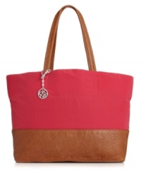 A chic take on the classic tote. This spacious nylon design from DKNY offers a stylish way to hold all your goodies no matter where your day takes you. A chic take on the classic tote. This spacious nylon design from DKNY offers a stylish way to hold all your goodies no matter where your day takes you.