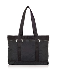 Durable ripstop nylon tote with double shoulder straps and three front exterior zip pockets. Top zip closure. Interior zip pocket. Lined. Durable ripstop nylon tote with double shoulder straps and three front exterior zip pockets. Top zip closure. Interior zip pocket. Lined.