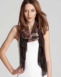 A large check pattern and earthy tones make this lightweight scarf a must-have this spring. A large check pattern and earthy tones make this lightweight scarf a must-have this spring.