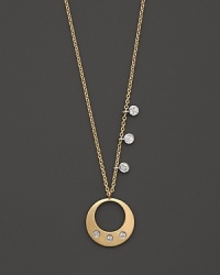 Diamonds and a circle pendant in 14K yellow gold. By Meira T. Diamonds and a circle pendant in 14K yellow gold. By Meira T.