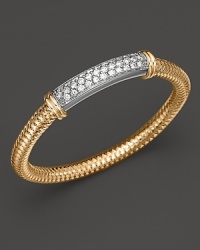 A modern 18K gold mesh bangle with dazzling diamond bar from Roberto Coin. A modern 18K gold mesh bangle with dazzling diamond bar from Roberto Coin.