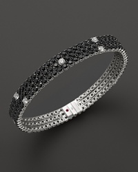 Faceted black sapphires, punctuated by diamonds, set in a dazzling 18K white gold band. By Roberto Coin. Faceted black sapphires, punctuated by diamonds, set in a dazzling 18K white gold band. By Roberto Coin.