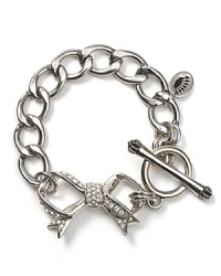 Juicy Couture takes their cult favorite starter bracelet in a dainty direction with a new pavé bow pendant. Juicy Couture takes their cult favorite starter bracelet in a dainty direction with a new pavé bow pendant.