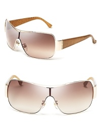 Rock the hottest silhouette to hit the runways in MICHAEL Michael Kors' sporty-chic shield sunglasses. Rock the hottest silhouette to hit the runways in MICHAEL Michael Kors' sporty-chic shield sunglasses.