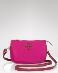 A stacked logo dresses up this understated Tory Burch handbag, styled for wear-with-all ease. A top zip secures the essentials, while a slim strap slides comfortably across the body. A stacked logo dresses up this understated Tory Burch handbag, styled for wear-with-all ease. A top zip secures the essentials, while a slim strap slides comfortably across the body.