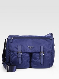 Vela fabric bandoleer bag with saffiano leather trim, adjustable shoulder strap, buckled flap pockets and a zip compartment on the flap.Adjustable shoulder strap, 15-23 dropZip flap closureEnamel triangle logoPolished steel hardwareTwo outside pockets with clasp on flapOne inside zip pocketPrada logo lining14W X 10H X 5½DMade in Italy Vela fabric bandoleer bag with saffiano leather trim, adjustable shoulder strap, buckled flap pockets and a zip compartment on the flap.Adjustable shoulder strap, 15-23 dropZip flap closureEnamel triangle logoPolished steel hardwareTwo outside pockets with clasp on flapOne inside zip pocketPrada logo lining14W X 10H X 5½DMade in Italy
