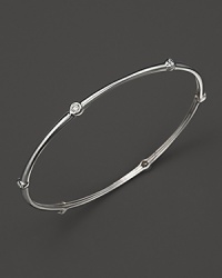 Faceted diamonds stud Roberto Coin's slim 18K. white gold bangle. Faceted diamonds stud Roberto Coin's slim 18K. white gold bangle.