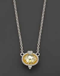 A romantic heart tops this faceted, oval-cut canary crystal pendant, in sterling silver. A romantic heart tops this faceted, oval-cut canary crystal pendant, in sterling silver.
