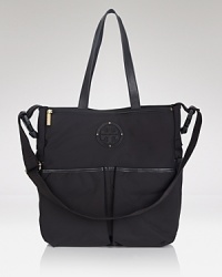 With an included changing pad, 4 handy exterior snap pockets (and 3 more inside,) this easy-to-clean nylon Tory Burch baby bag is a special delivery. Carry it as a new mom must-have. With an included changing pad, 4 handy exterior snap pockets (and 3 more inside,) this easy-to-clean nylon Tory Burch baby bag is a special delivery. Carry it as a new mom must-have.