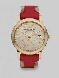 An iconic haymarket check strap with a pop of brilliant color in supple leather on a goldtone case. Quartz movementWater resistant to 5 ATMRound goldtone stainless steel case, 38mm (1.5)Smooth bezelLight trench check stamped dialBar hour markersDate display at 3 o'clockSecond hand Red leather accented haymarket check strapMade in Switzerland An iconic haymarket check strap with a pop of brilliant color in supple leather on a goldtone case. Quartz movementWater resistant to 5 ATMRound goldtone stainless steel case, 38mm (1.5)Smooth bezelLight trench check stamped dialBar hour markersDate display at 3 o'clockSecond hand Red leather accented haymarket check strapMade in Switzerland