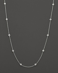 A diamond station necklace with signature ruby accent. Designed by Roberto Coin. A diamond station necklace with signature ruby accent. Designed by Roberto Coin.