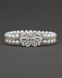 Double stranded bracelet of cultured, freshwater pearls accented with a diamond bow clasp. Double stranded bracelet of cultured, freshwater pearls accented with a diamond bow clasp.