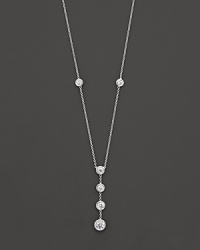 White gold bezel-set diamond necklace with four-stone drop pendant. With signature ruby accent. Designed by Roberto Coin. White gold bezel-set diamond necklace with four-stone drop pendant. With signature ruby accent. Designed by Roberto Coin.