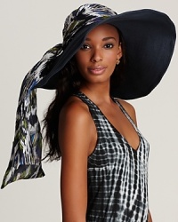 A finely braided floppy hat with a chic multicolored ikat print tie, a must-have for the beach-loving bunch. A finely braided floppy hat with a chic multicolored ikat print tie, a must-have for the beach-loving bunch.