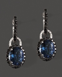 Diamonds and black diamonds circle faceted London blue topaz, set in 14K white gold. Diamonds and black diamonds circle faceted London blue topaz, set in 14K white gold.