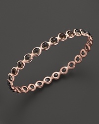 Smokey quartz stations dot a polished rosegold bangle from Ippolita. Smokey quartz stations dot a polished rosegold bangle from Ippolita.