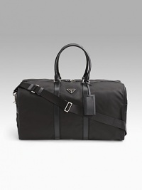 Tessuto nylon duffel bag with saffiano leather trim. Removable/adjustable shoulder strap Double short saffiano leather top handles Top zip closure Prada jacquard lining 21W X 11½H X 9½D Made in Italy 