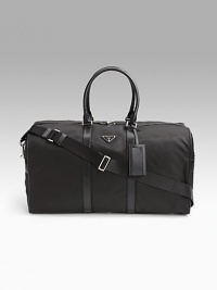 Tessuto nylon duffel bag with saffiano leather trim. Removable/adjustable shoulder strap Double short saffiano leather top handles Top zip closure Prada jacquard lining 21W X 11½H X 9½D Made in Italy Tessuto nylon duffel bag with saffiano leather trim. Removable/adjustable shoulder strap Double short saffiano leather top handles Top zip closure Prada jacquard lining 21W X 11½H X 9½D Made in Italy